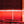 Load image into Gallery viewer, Glowing room with red light therapy device.