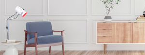 Targeted red light therapy device positioned to be used while in a reading chair relaxing.