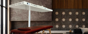 Urban studio with commercial red light therapy device over a red massage table.