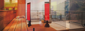 Modern commercial sauna with two red light therapy panels on stands.