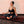Load image into Gallery viewer, Woman meditating on a pemf mat with red light.