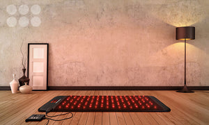 Grounding mats earthling on the floor. PEMF mats that include full body red light therapy mat glowing red.