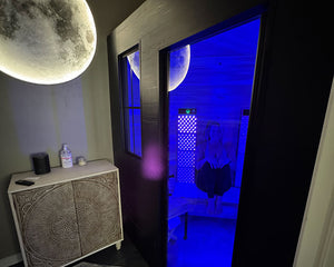 Custom built modern sauna with red and infrared light therapy panels.