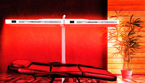 Full body red light bed in a red glowing red light therapy room.