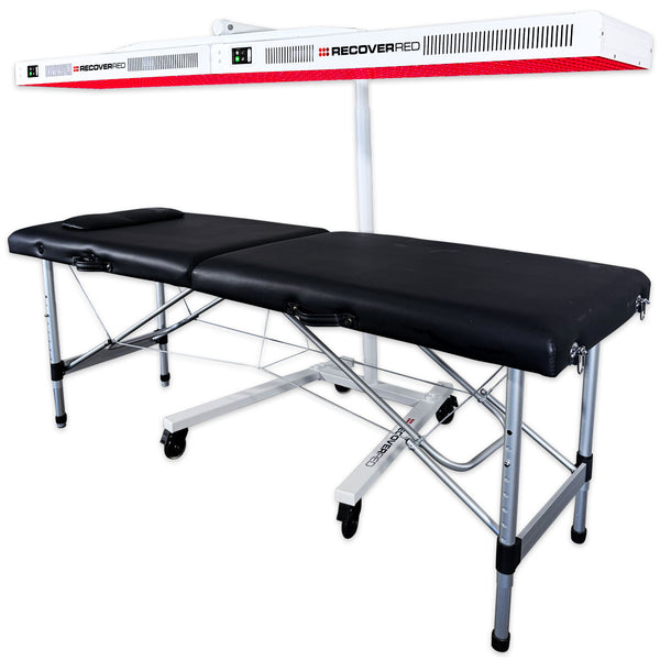 Massage table with red light therapy panels above.