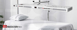 RecoverED LED light therapy unit on a white bed with a white background