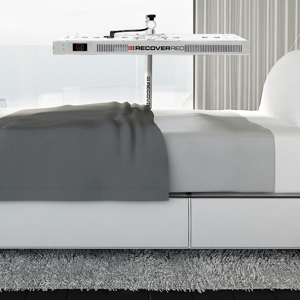 Red light lights over a bed in a bedroom setting.