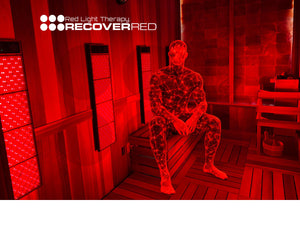 Athlete sitting in a red light therapy sauna with 'Recover RED' branding.