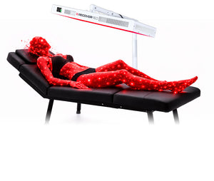 Anatomical model of a human body under a red light therapy panel.