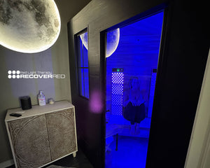 Custom built modern sauna with red and infrared light therapy panels.