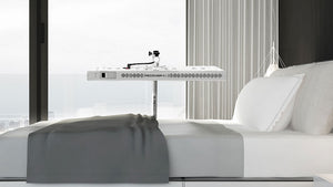 Modern bedroom with a bed and a canopy styled light lamp over the bed.