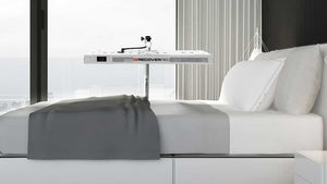 Modern bedroom with a bed and a canopy styled light lamp over the bed.