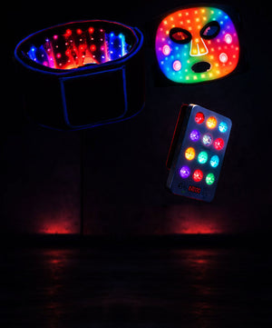 Colorful LED mask and light-up belt with remote control on a dark background.